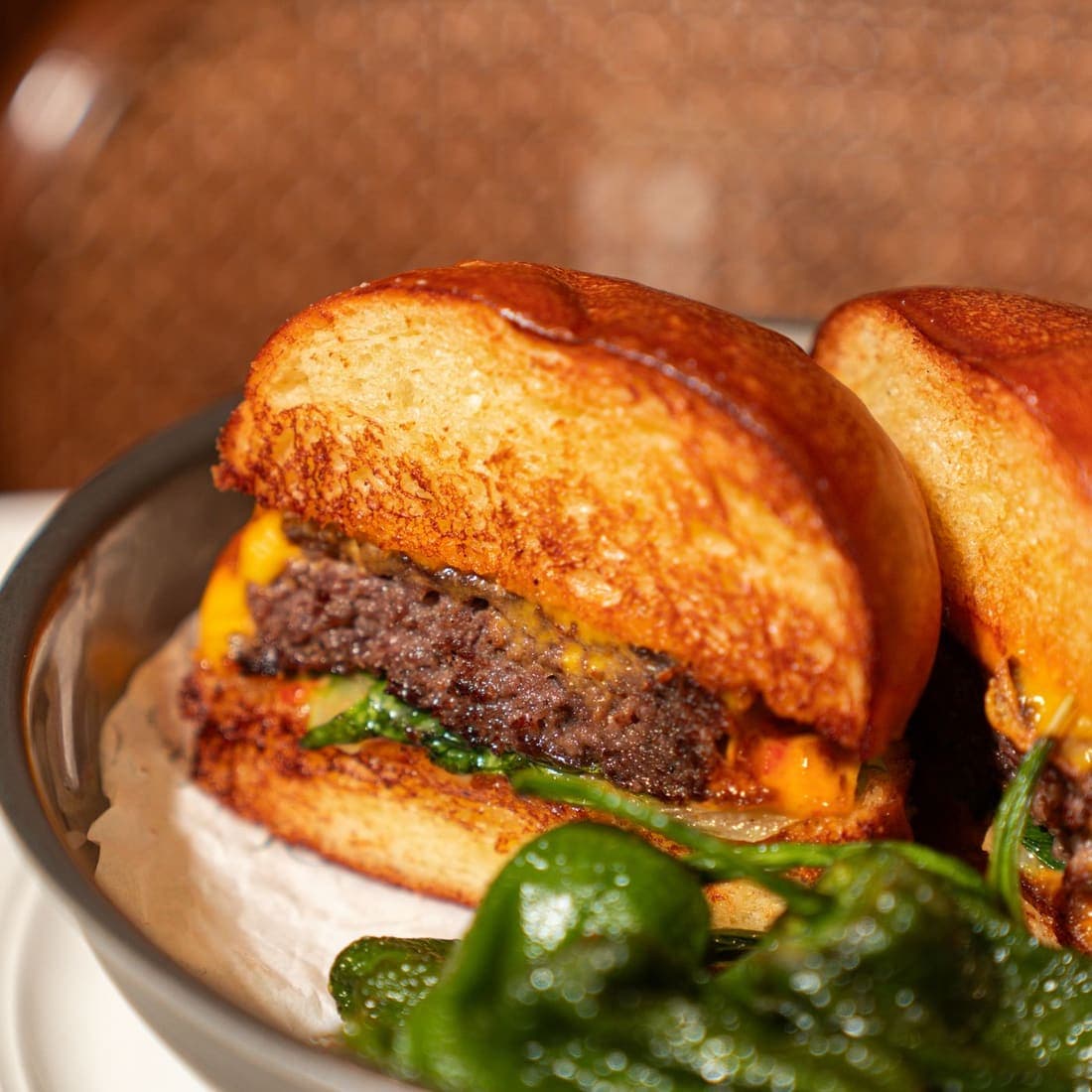 Grilled lamb burger with emmental cheese and greens