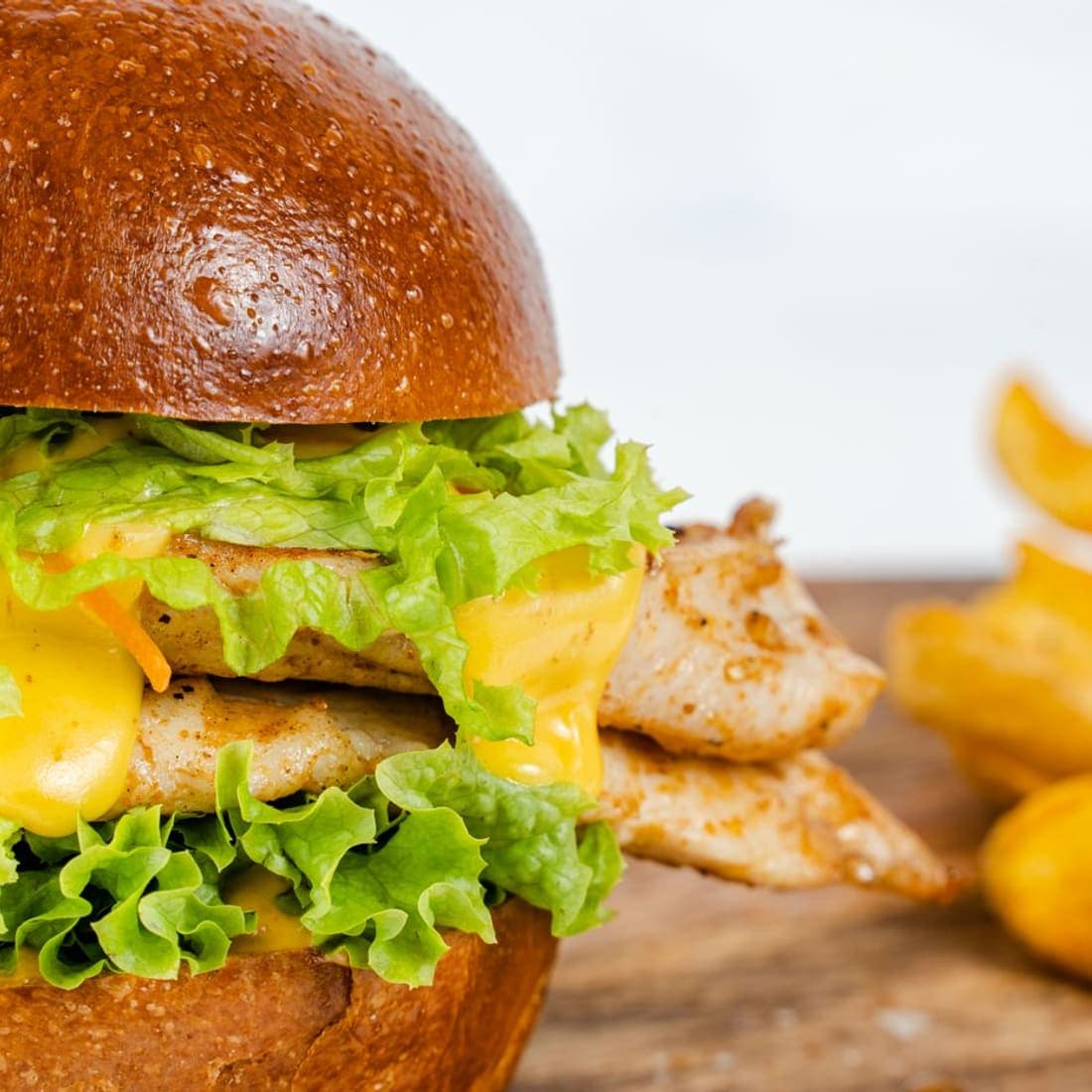 Grilled chicken burger with cheese and lettuce