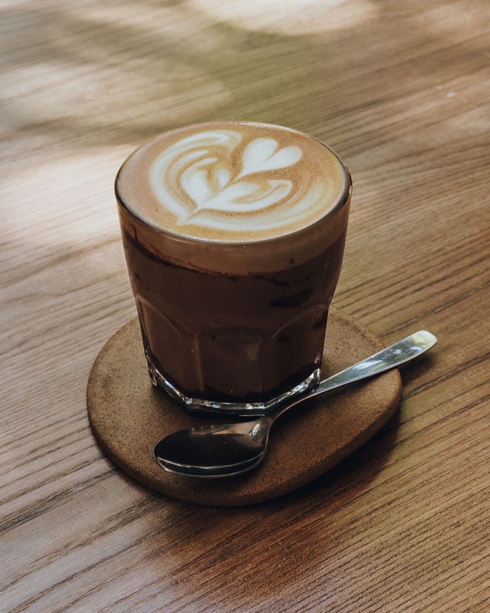 Latte with rosetta art in a glass
