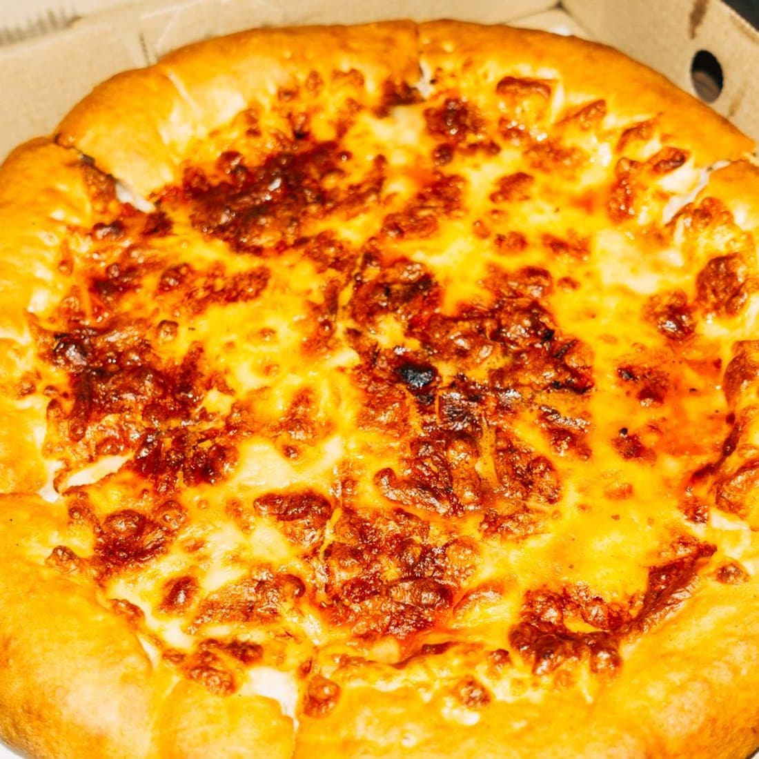 Stuffed crust cheese pizza in an open box
